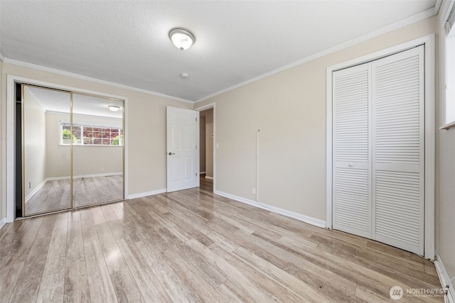 11401 69th Pl S, Seattle, WA 98178 - unfurnished bedroom with light wood finished floors, crown molding, and baseboards