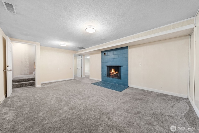 11401 69th Pl S, Seattle, WA 98178 - unfurnished living room with a textured ceiling, carpet flooring, a fireplace, baseboards, and stairway