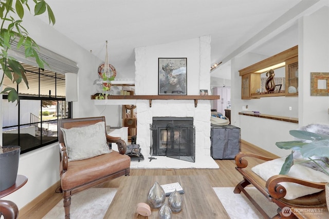 23708 Locust Way Unit 8B, Bothell, WA 98021 - living area with wood finished floors, a stone fireplace, and baseboards