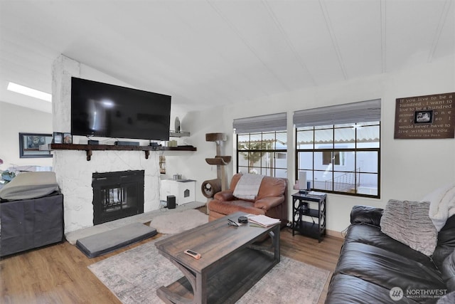 23708 Locust Way Unit 8B, Bothell, WA 98021 - living room featuring wood finished floors, vaulted ceiling, and a fireplace
