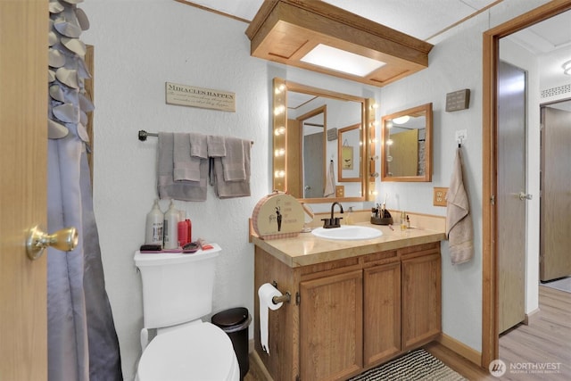 23708 Locust Way Unit 8B, Bothell, WA 98021 - bathroom featuring vanity, wood finished floors, and toilet