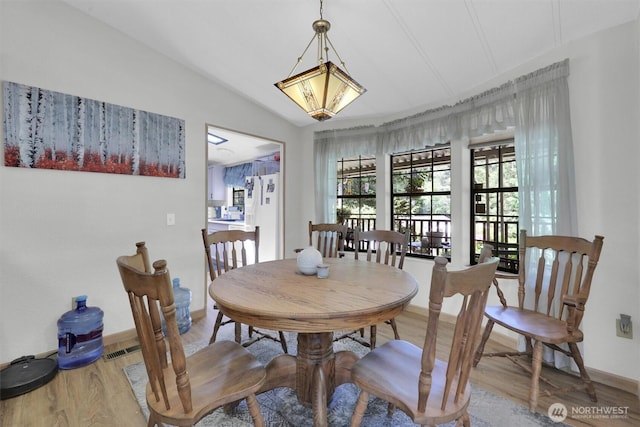 23708 Locust Way Unit 8B, Bothell, WA 98021 - dining room with wood finished floors, baseboards, and lofted ceiling