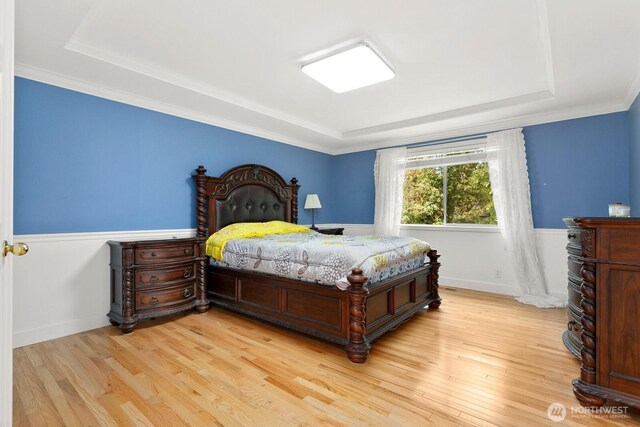 33325 12th Ave SW, Federal Way, WA 98023 - bedroom with a raised ceiling, light wood-style flooring, ornamental molding, and a wainscoted wall