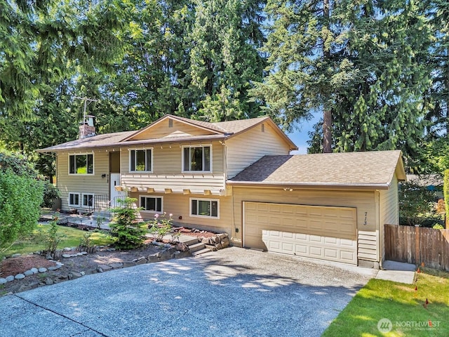 713 220th St SW, Bothell, WA 98021 - view of front of house featuring driveway, an attached garage, roof with shingles, and a chimney