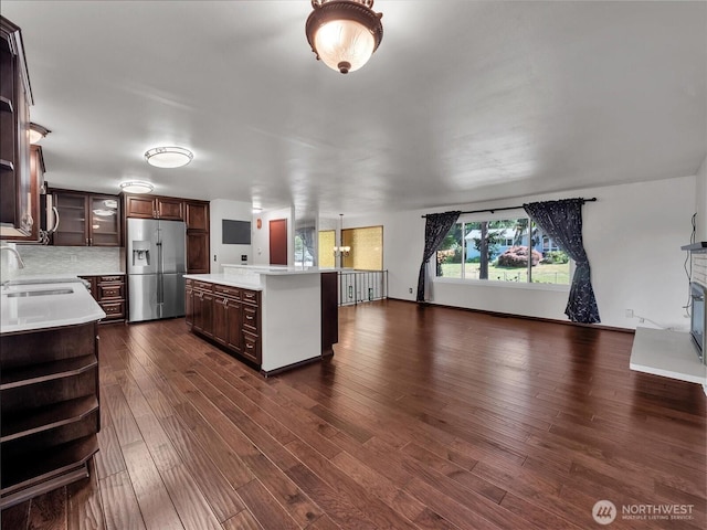 713 220th St SW, Bothell, WA 98021 - kitchen with stainless steel fridge, open floor plan, light countertops, dark wood finished floors, and a kitchen island