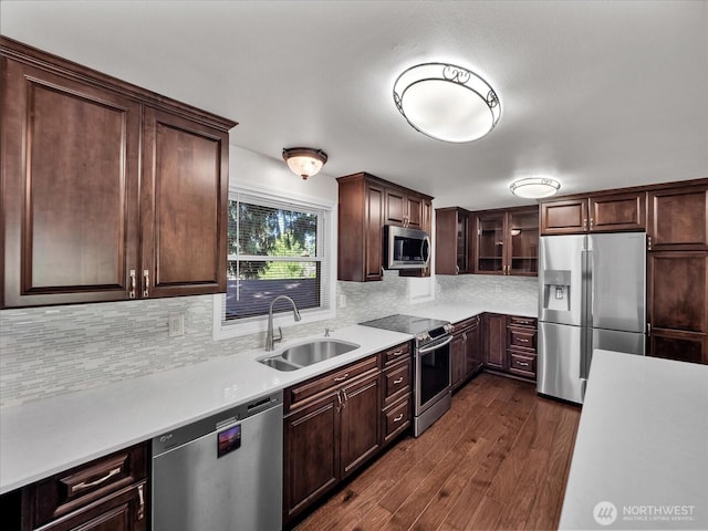 713 220th St SW, Bothell, WA 98021 - kitchen featuring appliances with stainless steel finishes, light countertops, dark wood-style flooring, and tasteful backsplash
