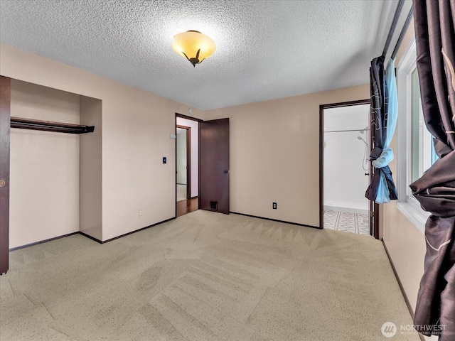 713 220th St SW, Bothell, WA 98021 - unfurnished bedroom featuring light carpet, a textured ceiling, and a closet
