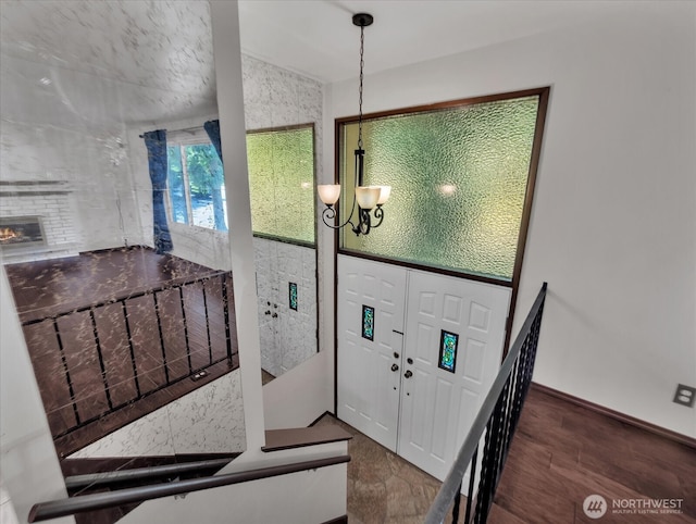 713 220th St SW, Bothell, WA 98021 - entrance foyer featuring a chandelier, wood finished floors, and a brick fireplace