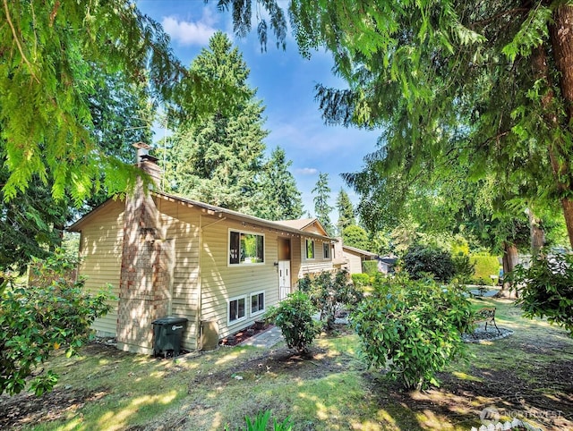 713 220th St SW, Bothell, WA 98021 - rear view of property with a chimney