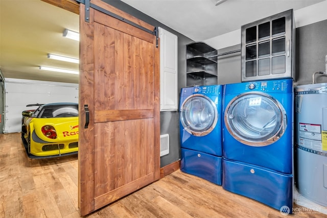 1811 Bay St, Port Orchard, WA 98366 - washroom with strapped water heater, wood finished floors, washing machine and clothes dryer, and cabinet space