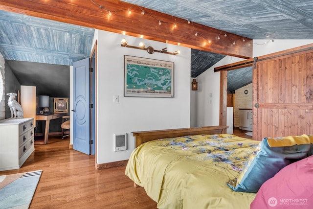 1811 Bay St, Port Orchard, WA 98366 - bedroom with a barn door, light wood finished floors, lofted ceiling, heating unit, and baseboards