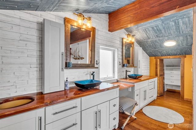 1811 Bay St, Port Orchard, WA 98366 - full bathroom with wood walls, wood finished floors, double vanity, and vaulted ceiling