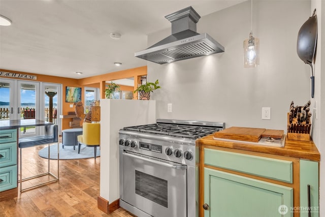 1811 Bay St, Port Orchard, WA 98366 - kitchen featuring stainless steel range, range hood, light wood-style flooring, green cabinets, and french doors
