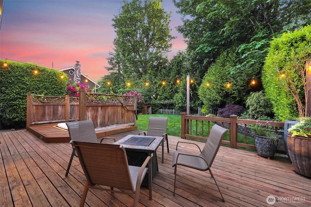 14937 104th Ave NE, Bothell, WA 98011 - deck at dusk featuring a fenced backyard and an outdoor fire pit