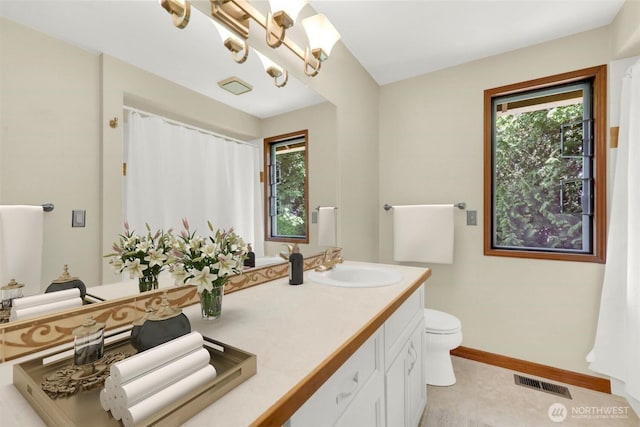 14937 104th Ave NE, Bothell, WA 98011 - bathroom with double vanity, toilet, baseboards, and a chandelier