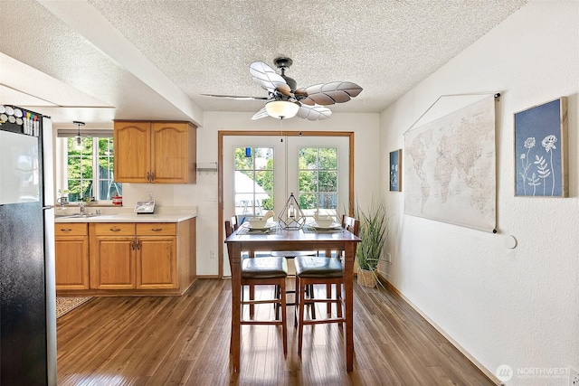 21301 118th Street Ct E, Bonney Lake, WA 98391 - dining space with ceiling fan, a textured ceiling, wood finished floors, and baseboards