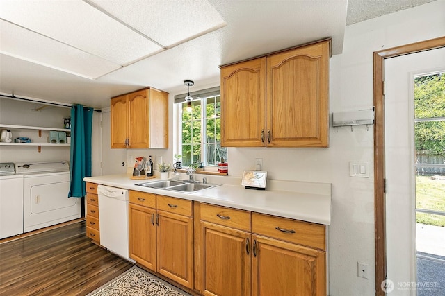 21301 118th Street Ct E, Bonney Lake, WA 98391 - kitchen featuring white dishwasher, a sink, washing machine and clothes dryer, dark wood-type flooring, and light countertops