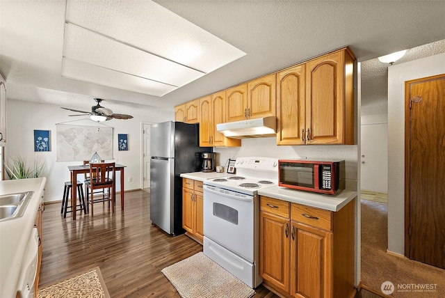 21301 118th Street Ct E, Bonney Lake, WA 98391 - kitchen with white range with electric stovetop, under cabinet range hood, freestanding refrigerator, dark wood-style floors, and ceiling fan