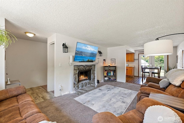 21301 118th Street Ct E, Bonney Lake, WA 98391 - living room featuring a textured ceiling, a stone fireplace, and wood finished floors