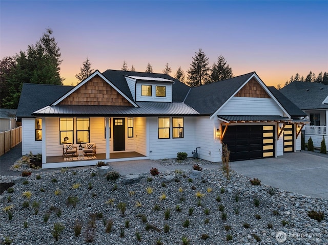 1516 131st Ave NE, Lake Stevens, WA 98258 - modern inspired farmhouse featuring a porch, metal roof, an attached garage, concrete driveway, and a standing seam roof