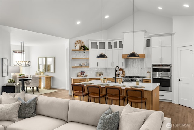1516 131st Ave NE, Lake Stevens, WA 98258 - living room featuring wood finished floors, recessed lighting, and high vaulted ceiling