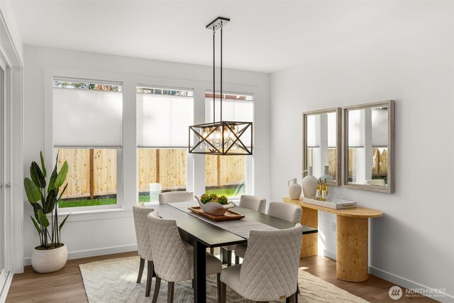 1516 131st Ave NE, Lake Stevens, WA 98258 - dining space with a chandelier, baseboards, and wood finished floors