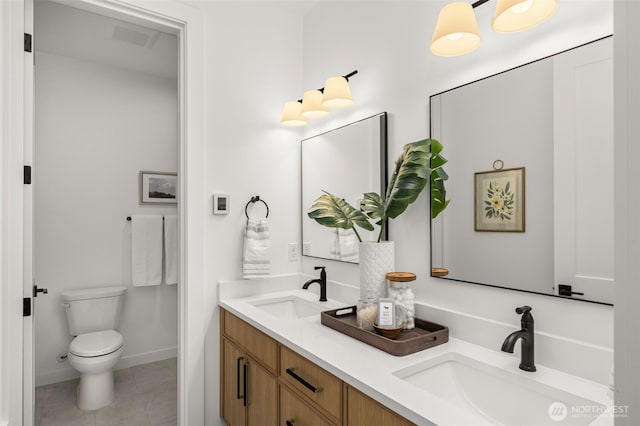 1516 131st Ave NE, Lake Stevens, WA 98258 - bathroom featuring double vanity, toilet, tile patterned floors, and baseboards