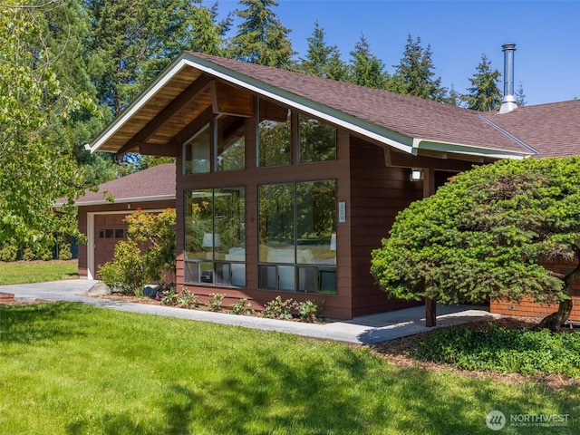 52 W Pheasant Ln, Sequim, WA 98382 - view of side of property with a garage, roof with shingles, and a lawn