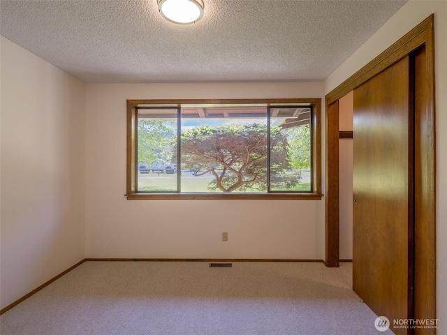 52 W Pheasant Ln, Sequim, WA 98382 - spare room featuring carpet, a textured ceiling, and baseboards