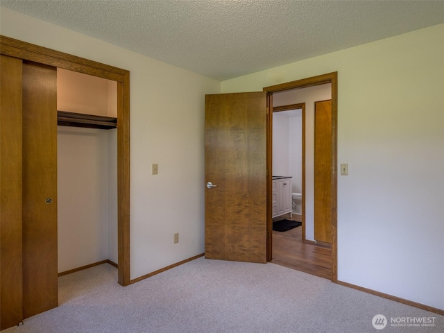 52 W Pheasant Ln, Sequim, WA 98382 - unfurnished bedroom featuring carpet flooring, a closet, baseboards, and a textured ceiling