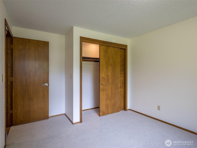 52 W Pheasant Ln, Sequim, WA 98382 - unfurnished bedroom featuring a closet, carpet floors, baseboards, and a textured ceiling