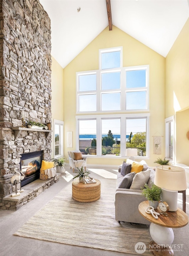 884 Saratoga Way, Camano Island, WA 98282 - living room featuring high vaulted ceiling, carpet floors, a stone fireplace, and beamed ceiling