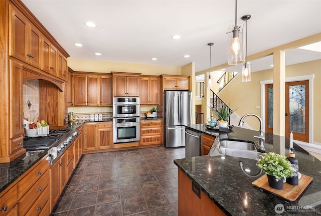884 Saratoga Way, Camano Island, WA 98282 - kitchen featuring stainless steel appliances, a sink, recessed lighting, brown cabinetry, and dark stone counters