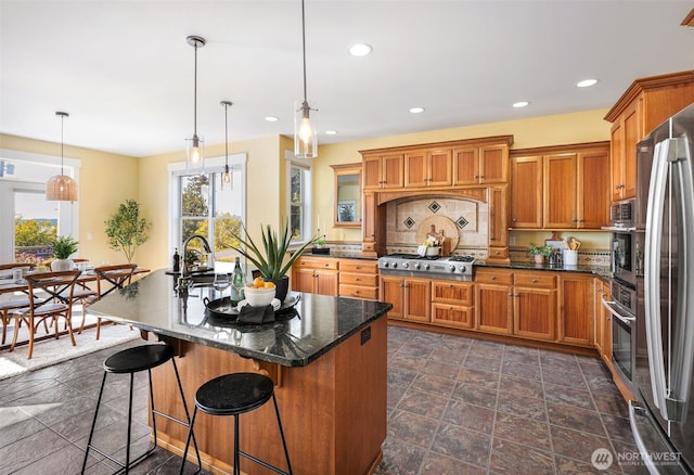 884 Saratoga Way, Camano Island, WA 98282 - kitchen with a sink, brown cabinets, appliances with stainless steel finishes, recessed lighting, and a kitchen breakfast bar