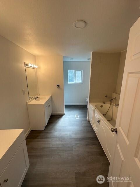 3722 Delphi Rd SW, Olympia, WA 98572 - bathroom with vanity, wood finished floors, a bath, and toilet