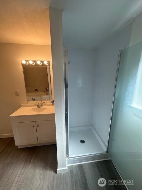 3722 Delphi Rd SW, Olympia, WA 98572 - full bath featuring wood finished floors, vanity, a walk in shower, and baseboards