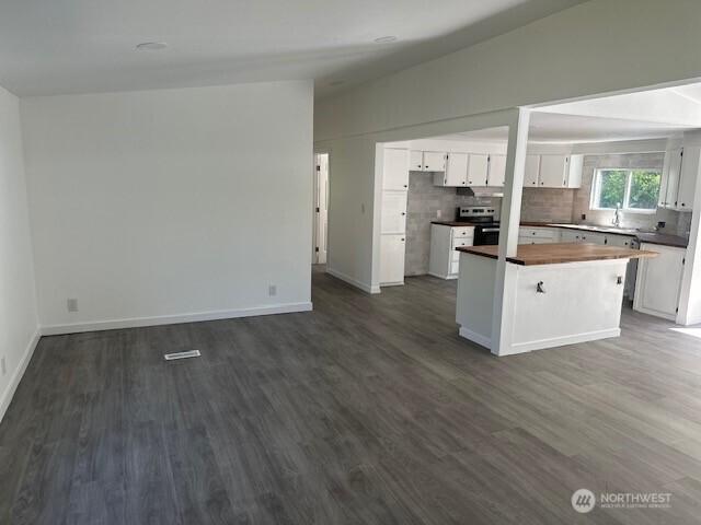 3722 Delphi Rd SW, Olympia, WA 98572 - kitchen with white cabinetry, dark wood finished floors, wooden counters, stainless steel electric range, and lofted ceiling