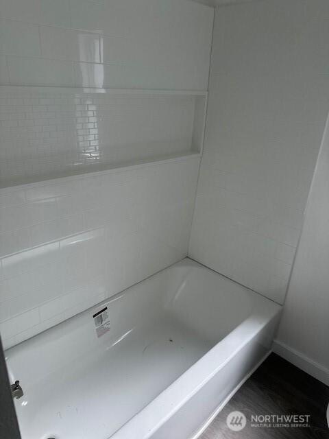 3722 Delphi Rd SW, Olympia, WA 98572 - bathroom featuring a bathtub, baseboards, and wood finished floors