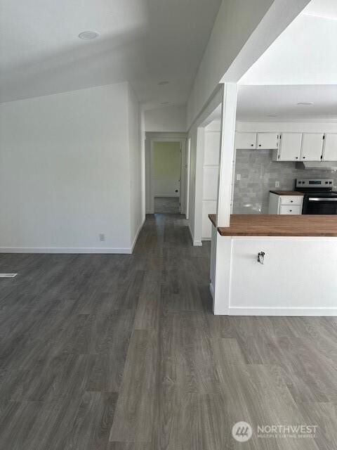 3722 Delphi Rd SW, Olympia, WA 98572 - kitchen with stainless steel electric range, white cabinetry, tasteful backsplash, dark wood finished floors, and baseboards