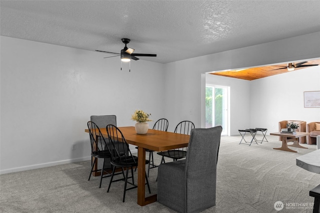 659 NW New York Ave, Chehalis, WA 98532 - carpeted dining room with ceiling fan, a textured ceiling, and baseboards