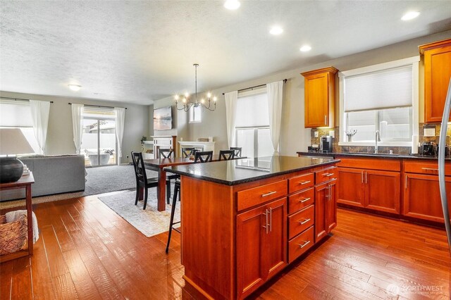 4709 W Fox St, Moses Lake, WA 98837 - kitchen featuring open floor plan, dark wood-style flooring, a chandelier, a sink, and recessed lighting