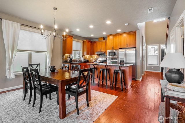 4709 W Fox St, Moses Lake, WA 98837 - dining space with a chandelier, dark wood-type flooring, baseboards, and recessed lighting
