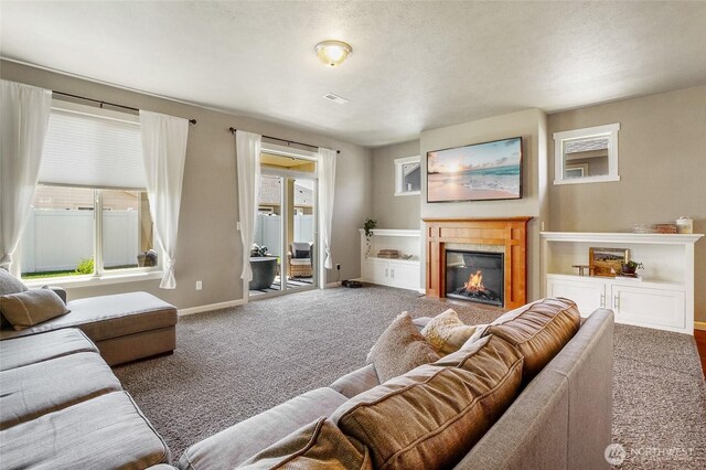 4709 W Fox St, Moses Lake, WA 98837 - carpeted living area with a glass covered fireplace and baseboards