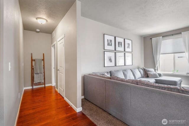 4709 W Fox St, Moses Lake, WA 98837 - living room with a textured ceiling, dark wood-type flooring, and baseboards