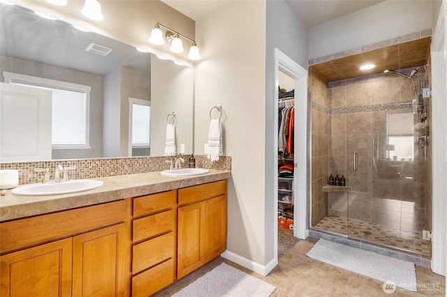 4709 W Fox St, Moses Lake, WA 98837 - full bath featuring a shower stall, double vanity, decorative backsplash, and a spacious closet
