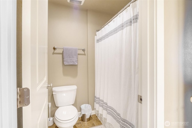 4709 W Fox St, Moses Lake, WA 98837 - bathroom with toilet, tile patterned flooring, baseboards, and a shower with curtain