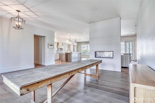 4942 Hurst Landing Rd, Rock Island, WA 98850 - dining space featuring healthy amount of natural light, light wood-style flooring, a multi sided fireplace, and recessed lighting