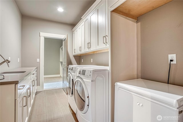 4942 Hurst Landing Rd, Rock Island, WA 98850 - washroom featuring washer and clothes dryer, recessed lighting, cabinet space, and baseboards