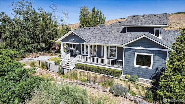 4942 Hurst Landing Rd, Rock Island, WA 98850 - view of front of property featuring a porch, a fenced backyard, roof with shingles, and a chimney