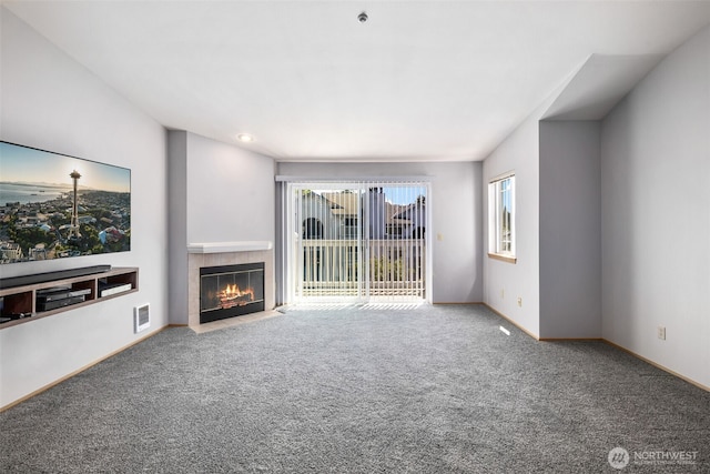 11325 19th Ave SE Unit C309, Everett, WA 98208 - unfurnished living room featuring carpet floors, a fireplace, and baseboards